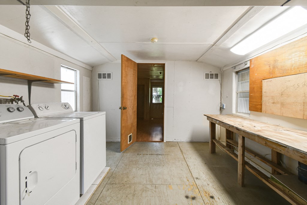 a laundry room with a stove and a wooden table
