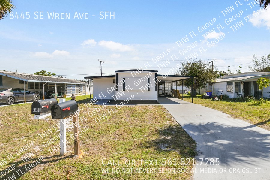 a house with a driveway and parking meters in front of it
