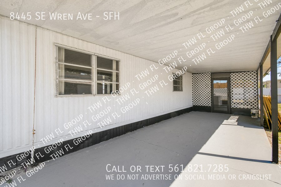 a porch with words written on the side of a building