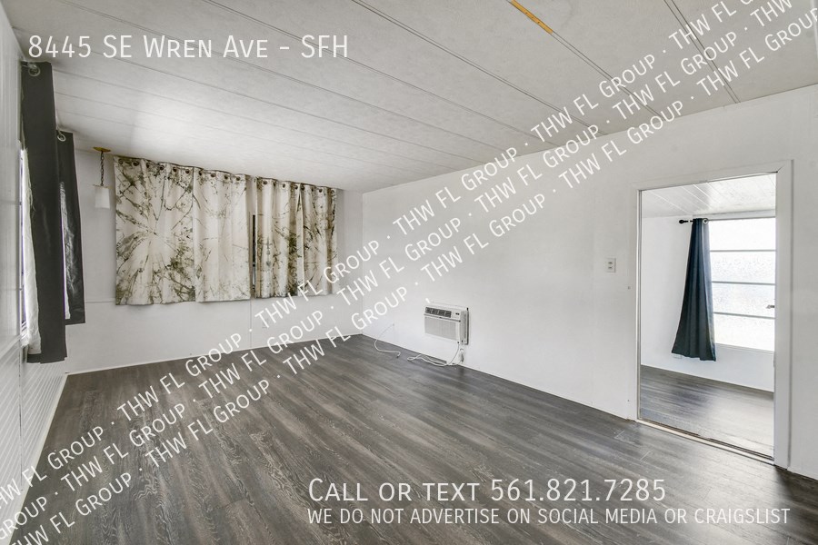 a large white room with text on the wall and a door