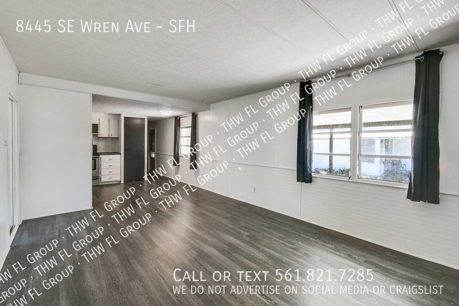 a large open living room with words on the wall of a house