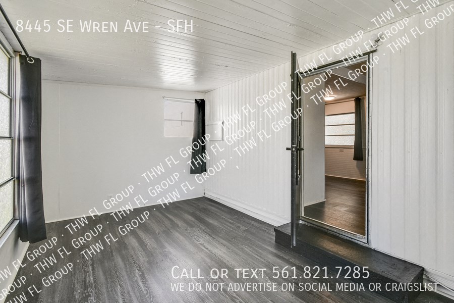 a small room with a door into a room with words on the wall