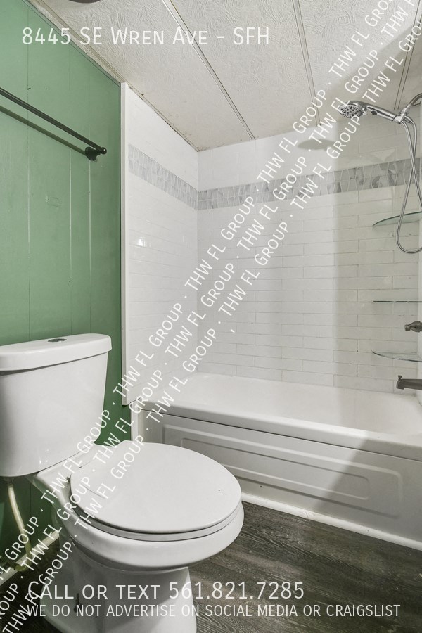 a small bathroom with a toilet and a bath tub