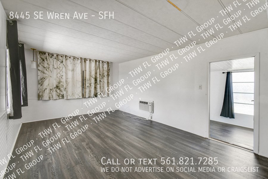 a large white room with text on the wall and a door