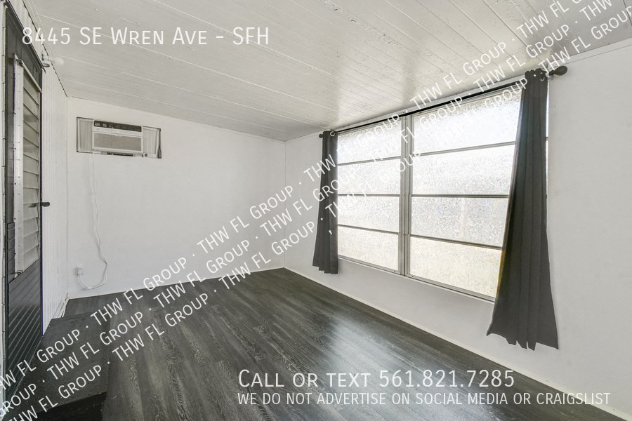 a room with a window and a curtain and words on the wall