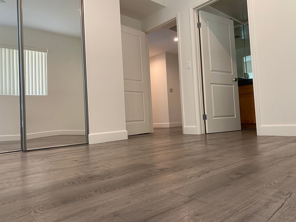A room with a wooden floor and a white door.
