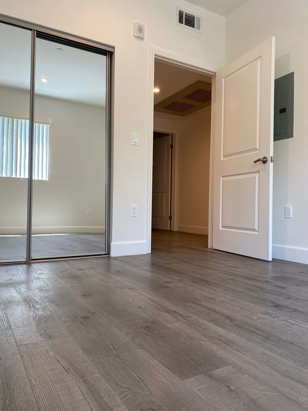 A room with a sliding glass door and a white door.