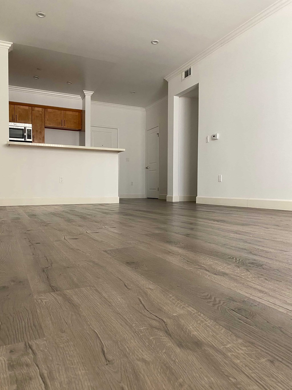 A room with a wooden floor and white walls.