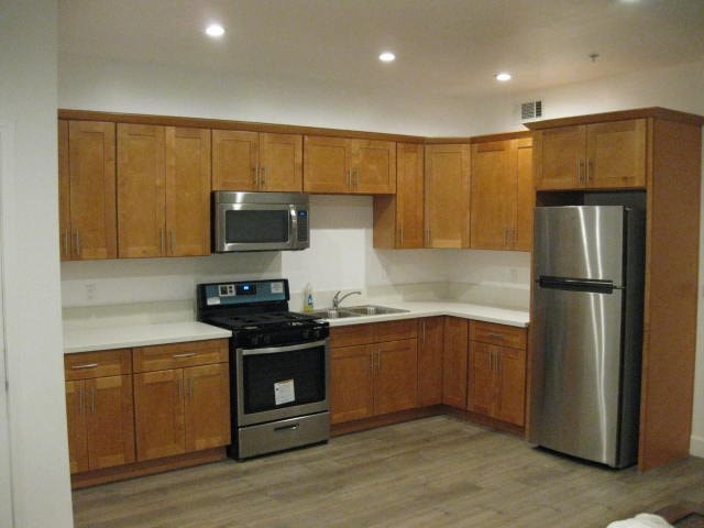 A kitchen with wooden cabinets and stainless steel appliances.