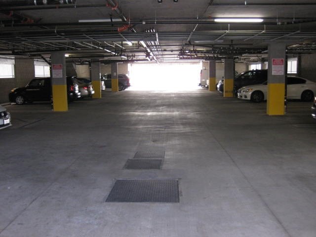 A parking garage with cars parked in it.