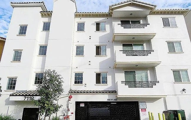 A white building with black doors and windows.