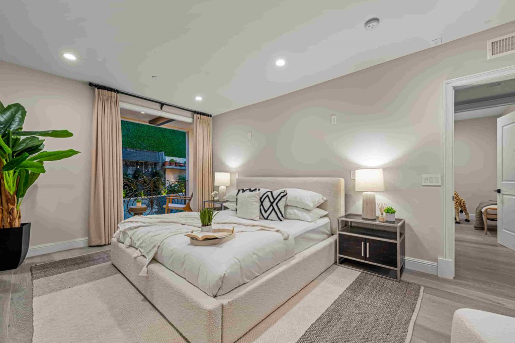 a white bedroom with a bed and a window