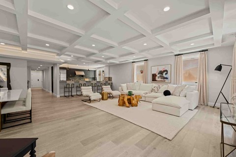 a large living room with a white couch and a rug