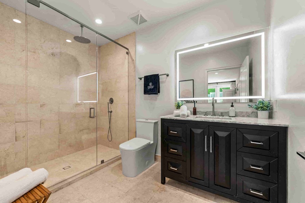 a bathroom with a shower and a sink and a mirror