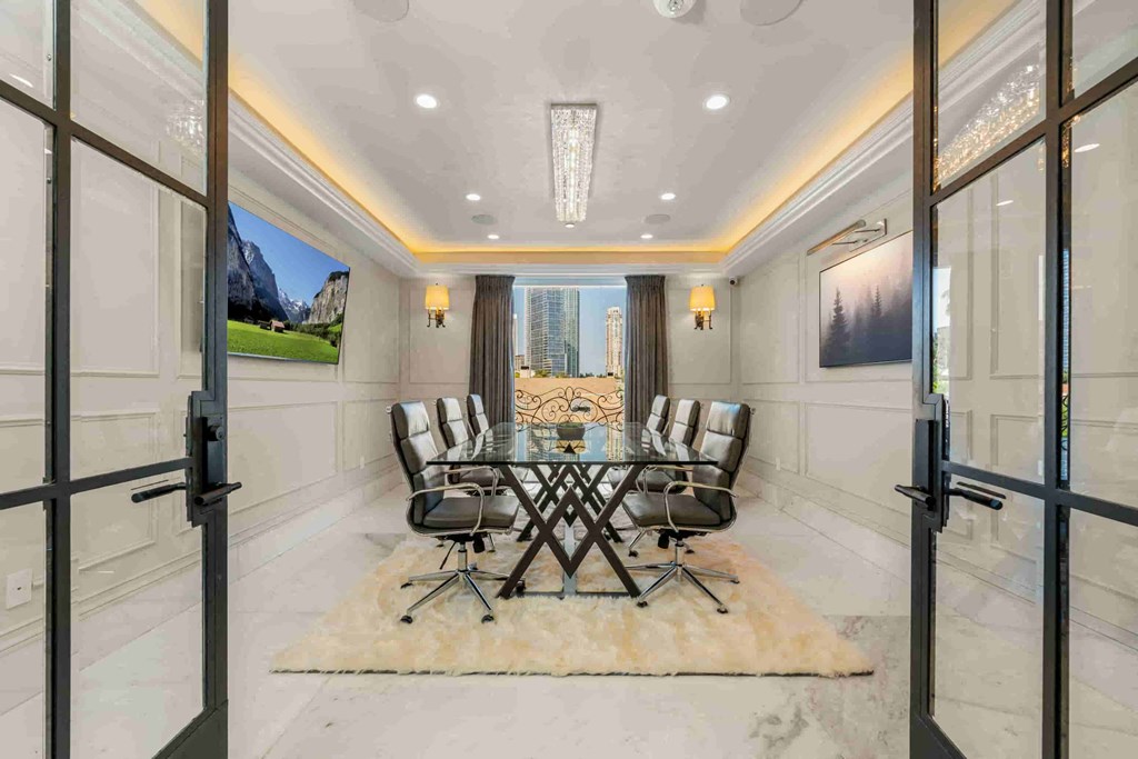 a dining room with a glass table and chairs