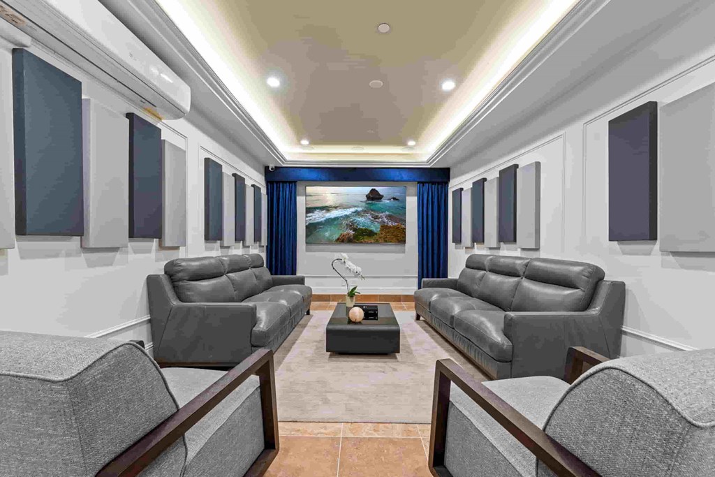 a living room with blue and white walls and gray couches