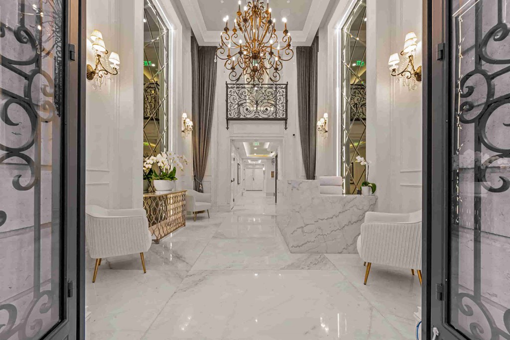 a hallway with a marble floor and a chandelier