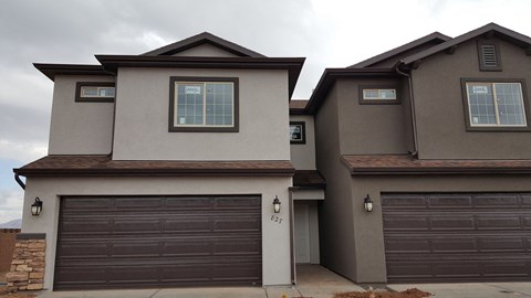 a house with two garage doors in front of it