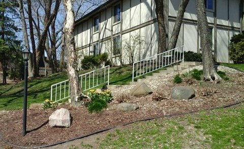a building with stairs and trees in front of it