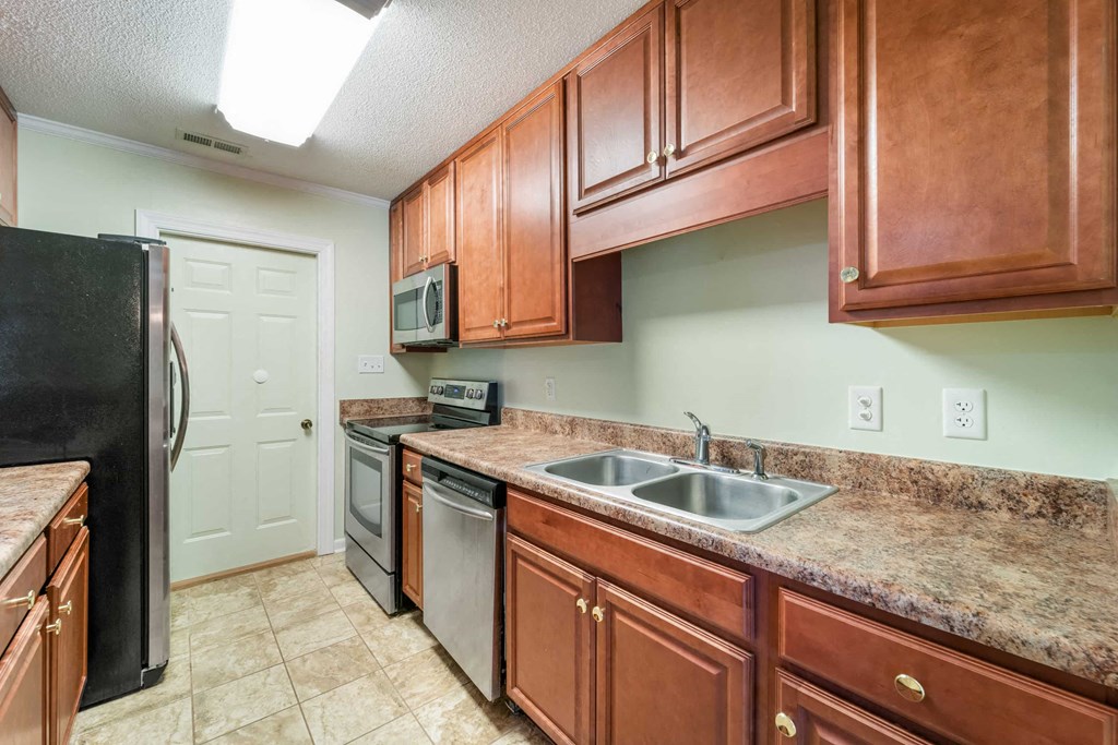 a kitchen with a sink and a refrigerator