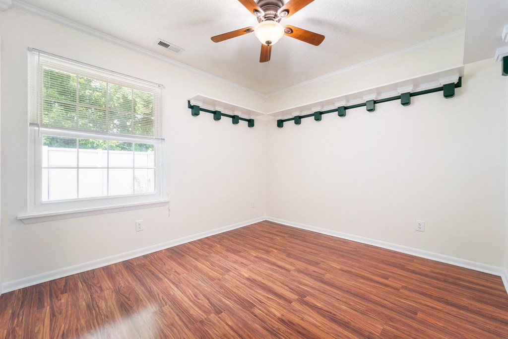 a living room with a ceiling fan and a window