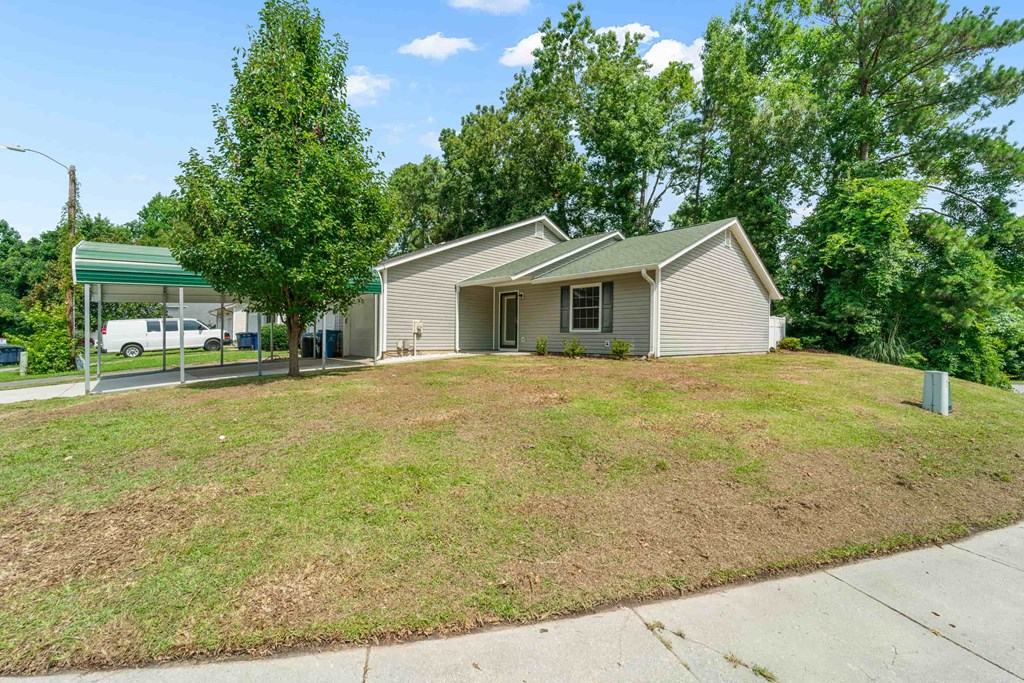 the front of a house with a lawn and a garage
