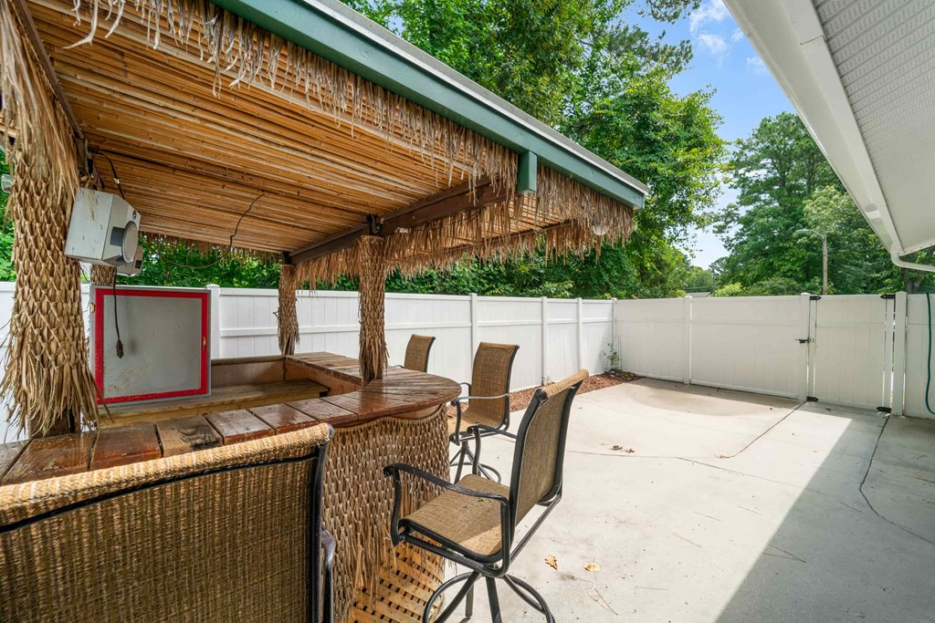a bar and seating area on the patio of a house