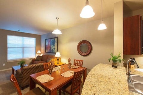 a kitchen and living room with a dining table