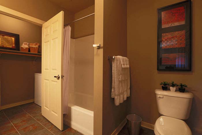 a bathroom with a toilet and a shower and a door