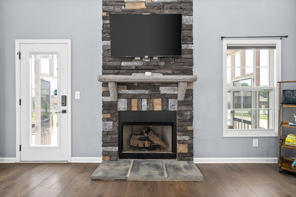 a living room with a fireplace and a television on top of it