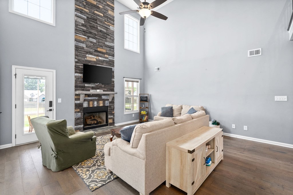 a living room with a couch and a chair and a fireplace