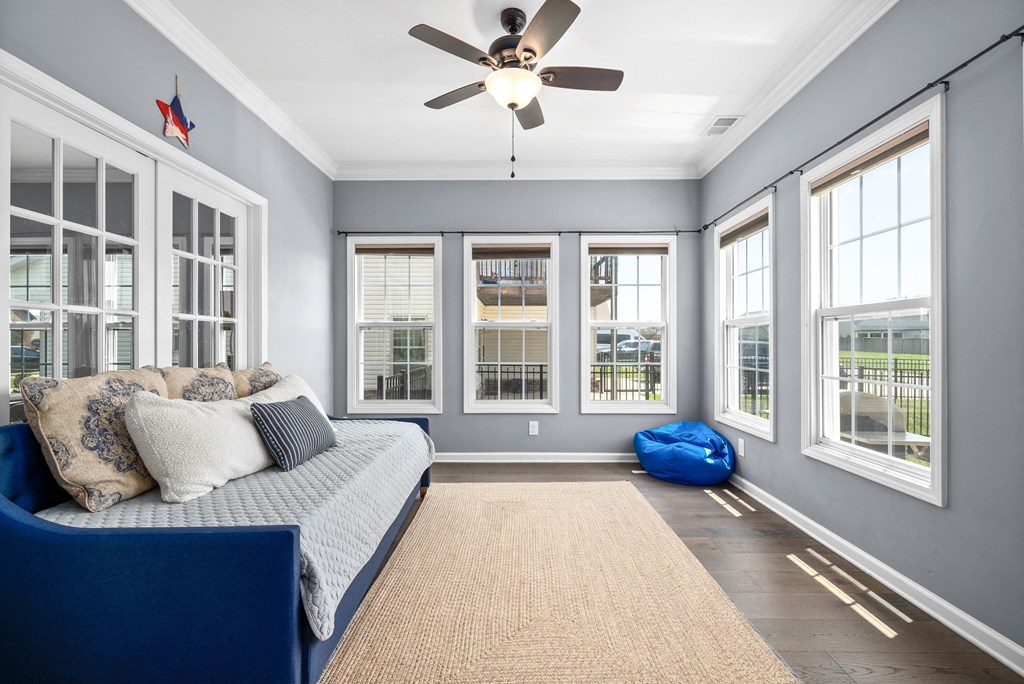 a living room with a couch and a ceiling fan