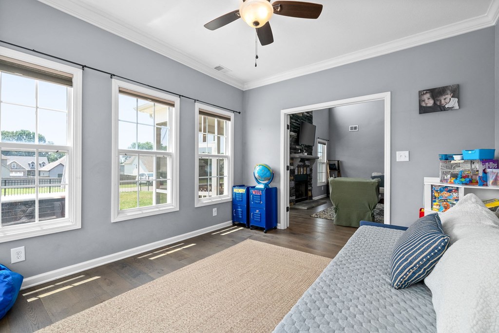 a living room with a couch and a ceiling fan