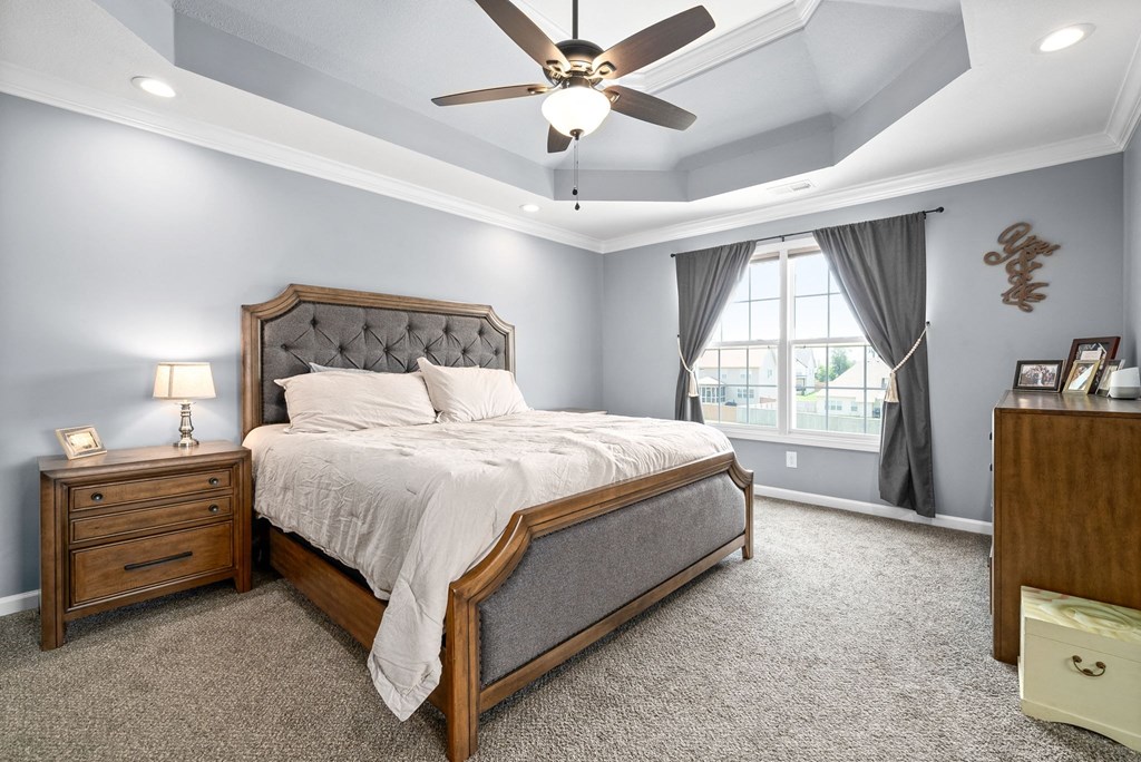 a bedroom with a bed and a ceiling fan