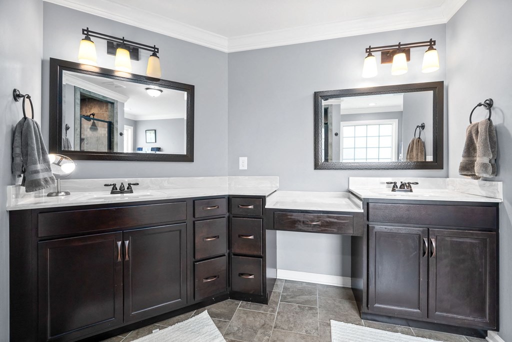 a bathroom with two sinks and a mirror