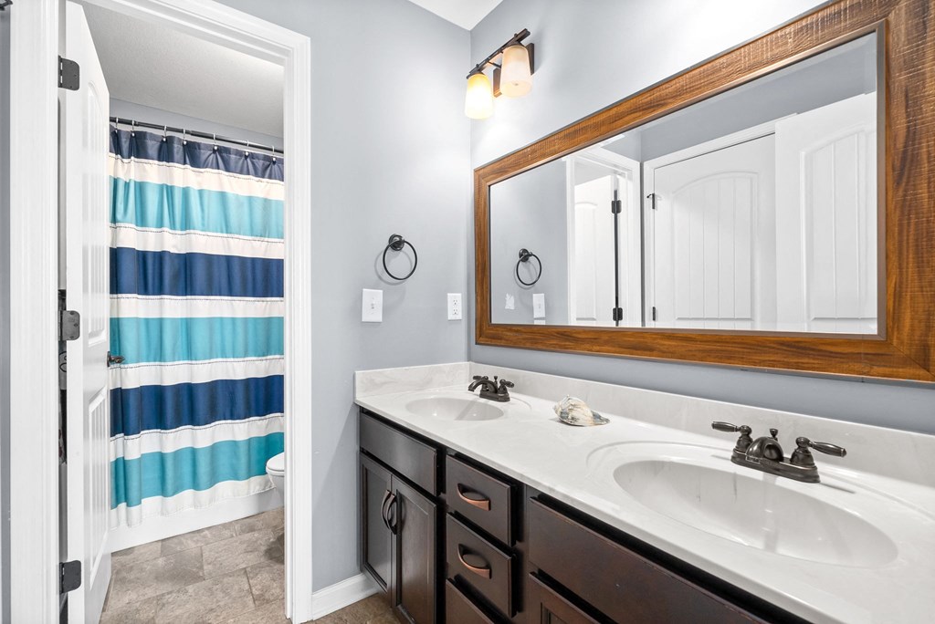 a bathroom with a sink and a mirror and a shower