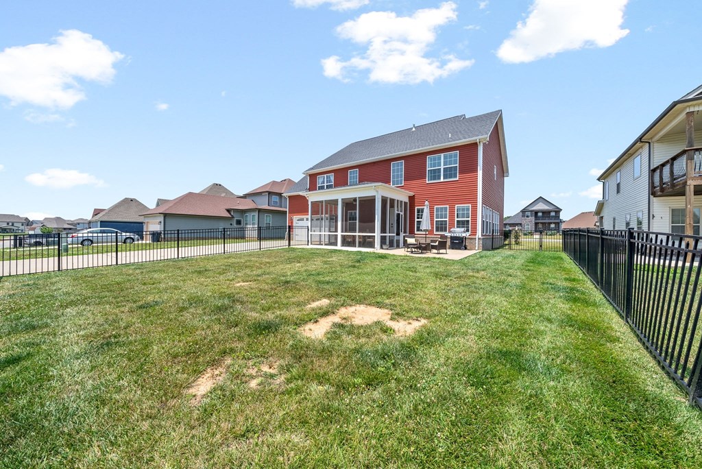 the backyard of a house with a yard and a fence