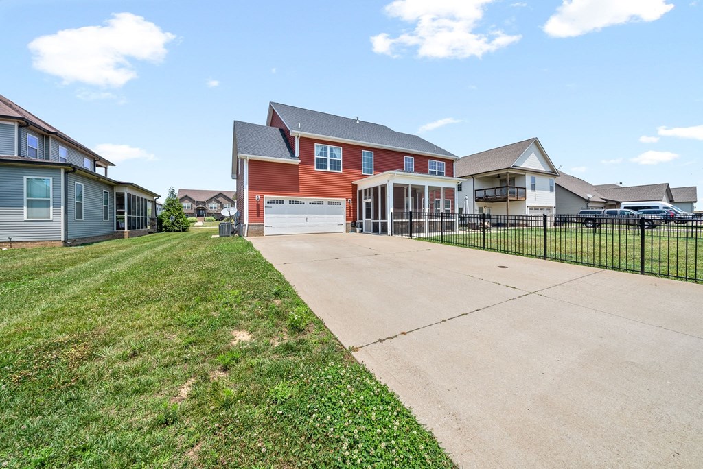 the drive way of a house with a driveway and a fence