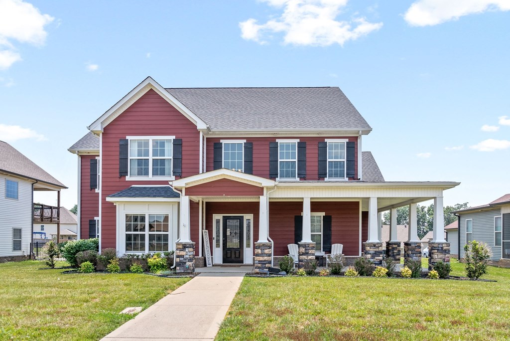 a red house with a sidewalk in front of it