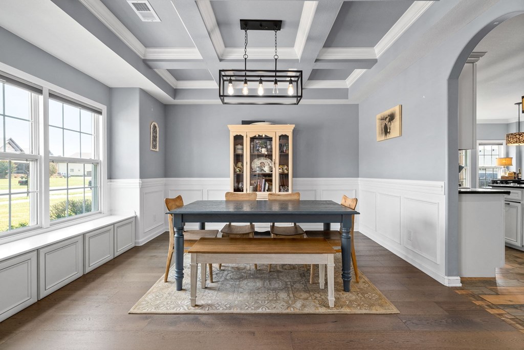 a dining room with a table and chairs and a large window