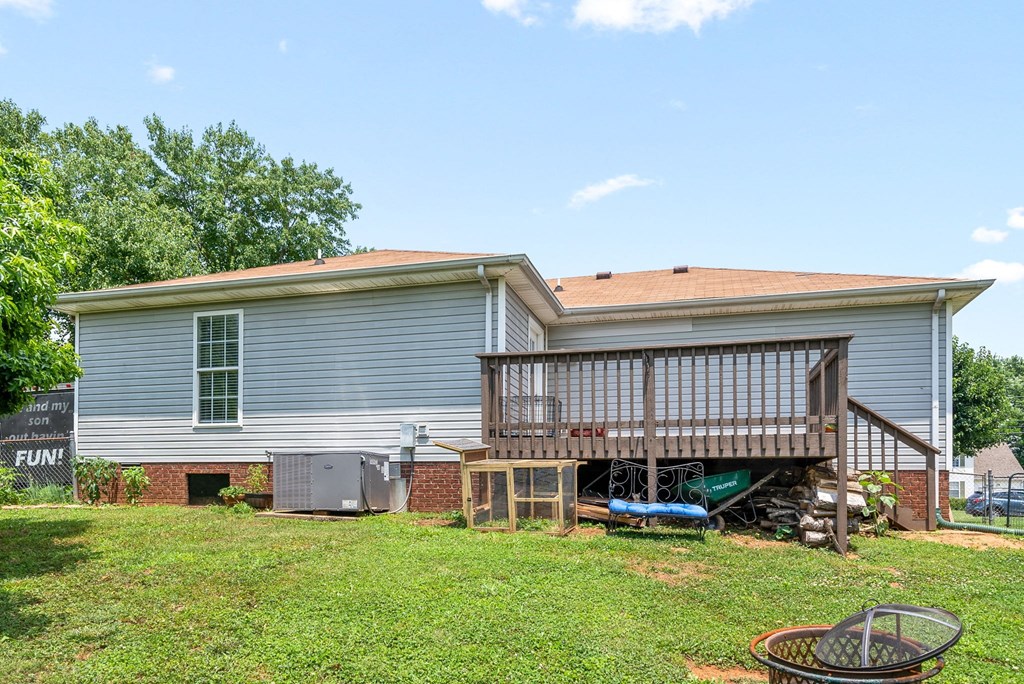 a blue house with a deck and a yard