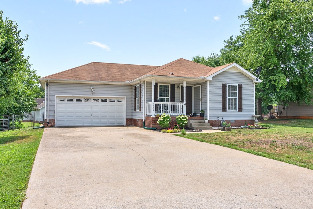 a white house with a driveway and a white garage door