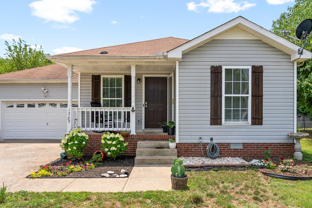 a white house with a porch and a white door