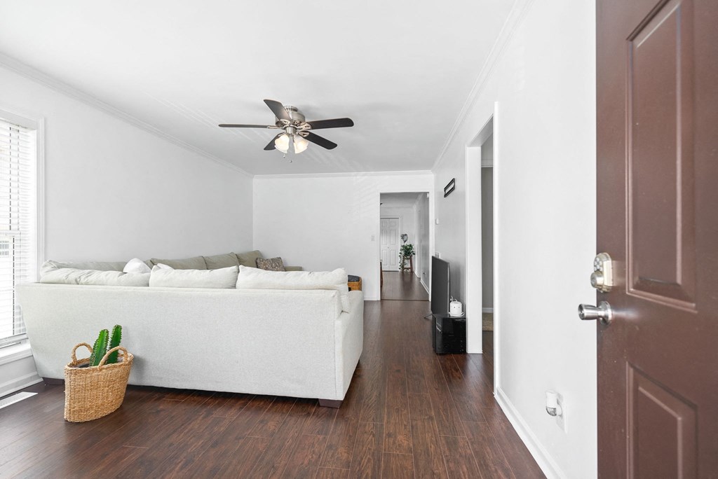 a living room with a couch and a ceiling fan
