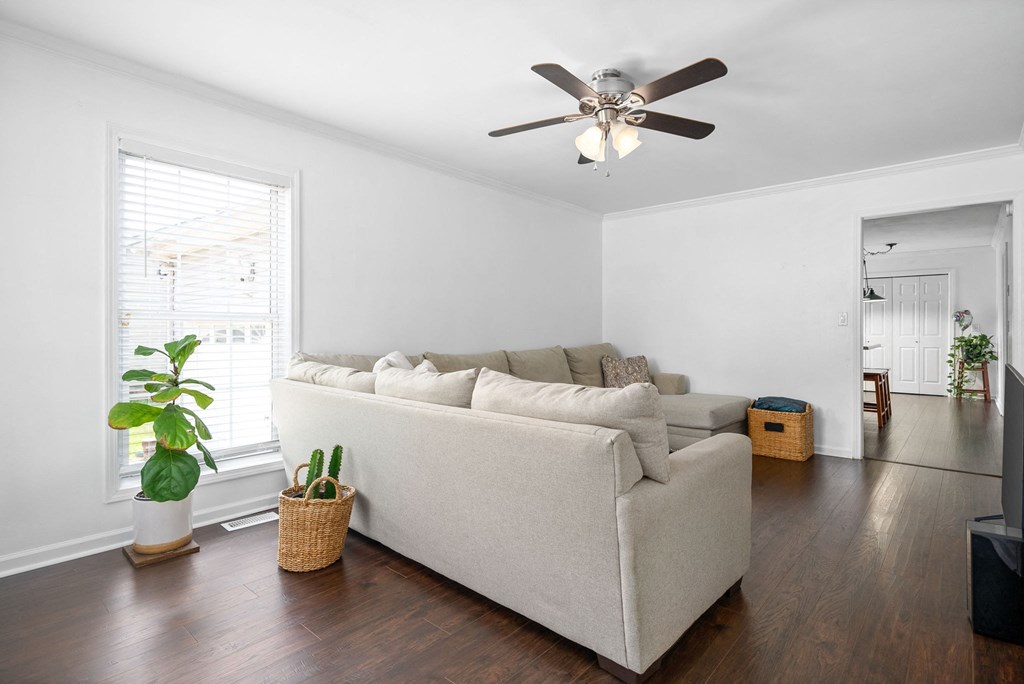 a living room with a couch and a ceiling fan
