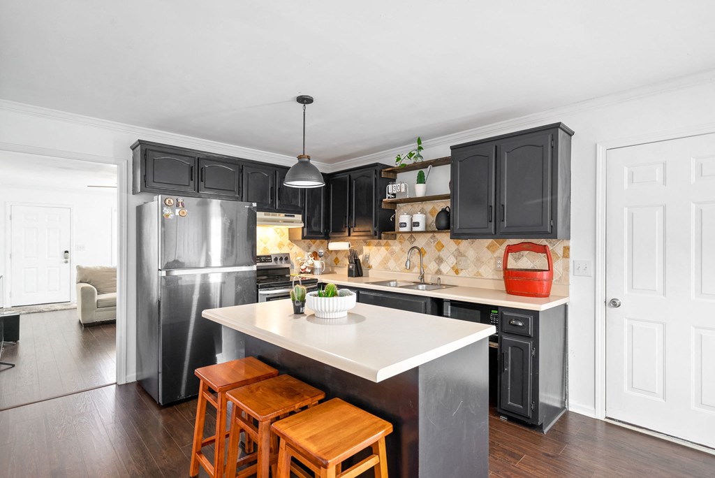 a kitchen with stainless steel appliances and black cabinets