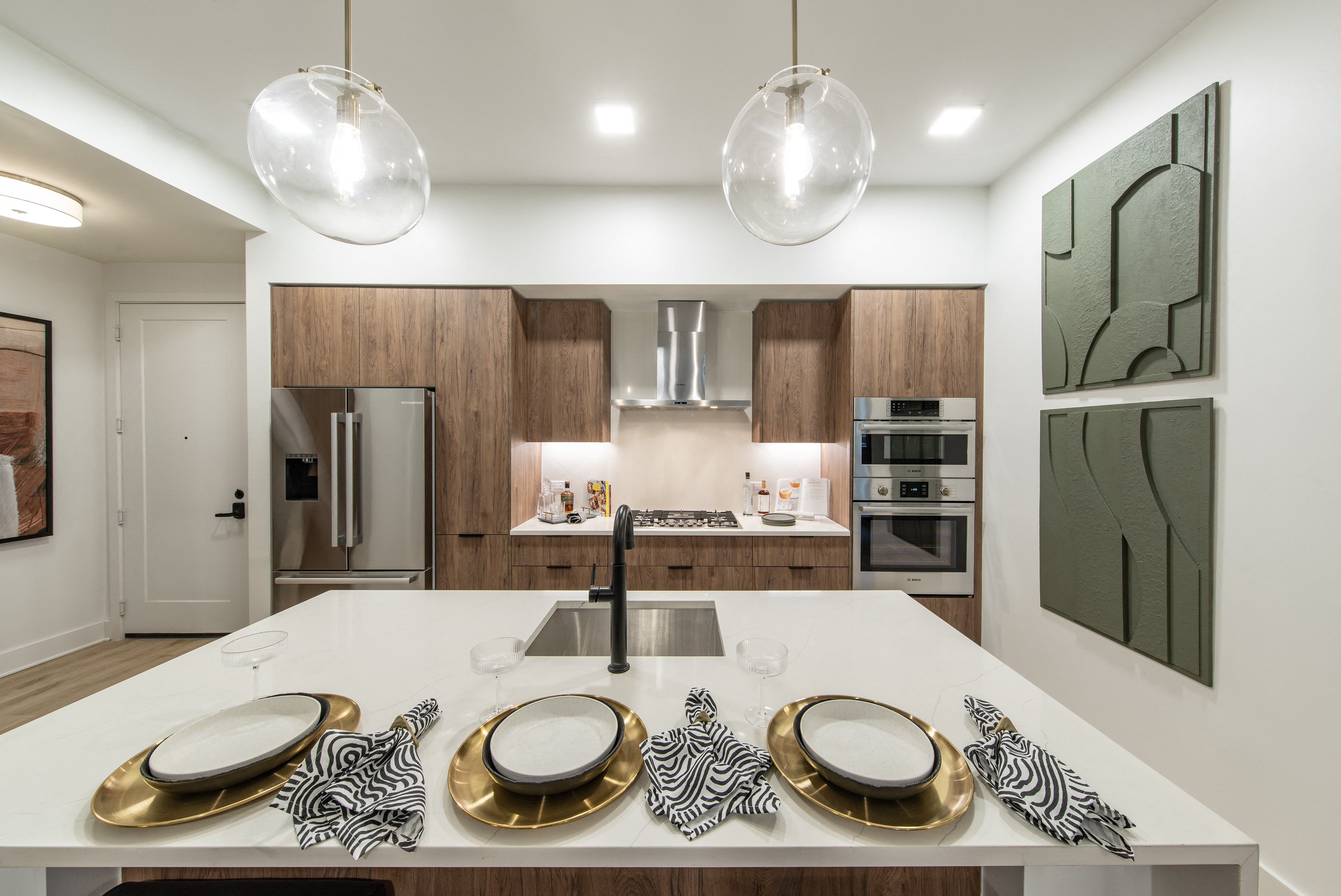 a kitchen with a white counter top and a sink