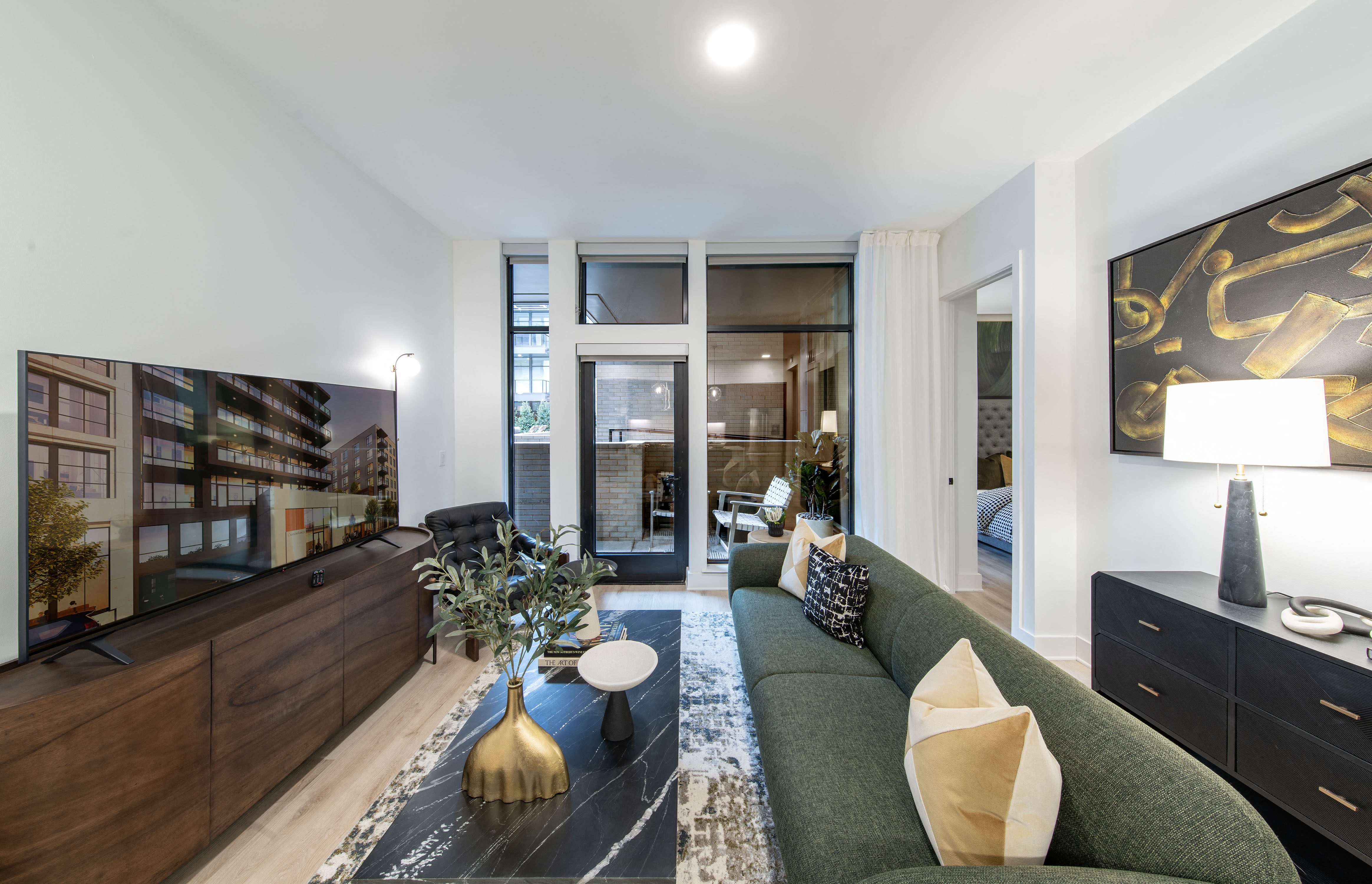 a living room with a green couch and a television