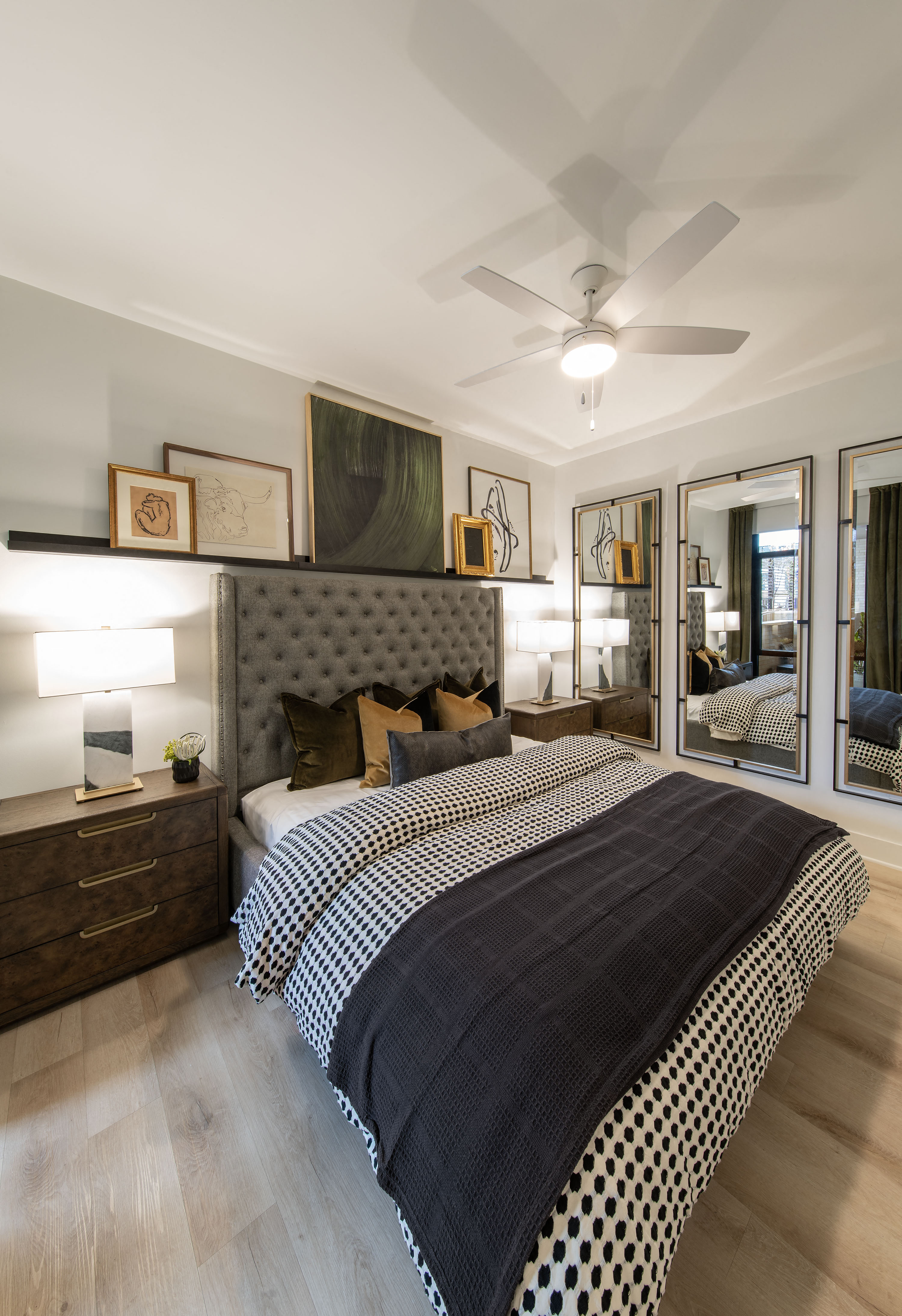 a bedroom with a bed and a ceiling fan