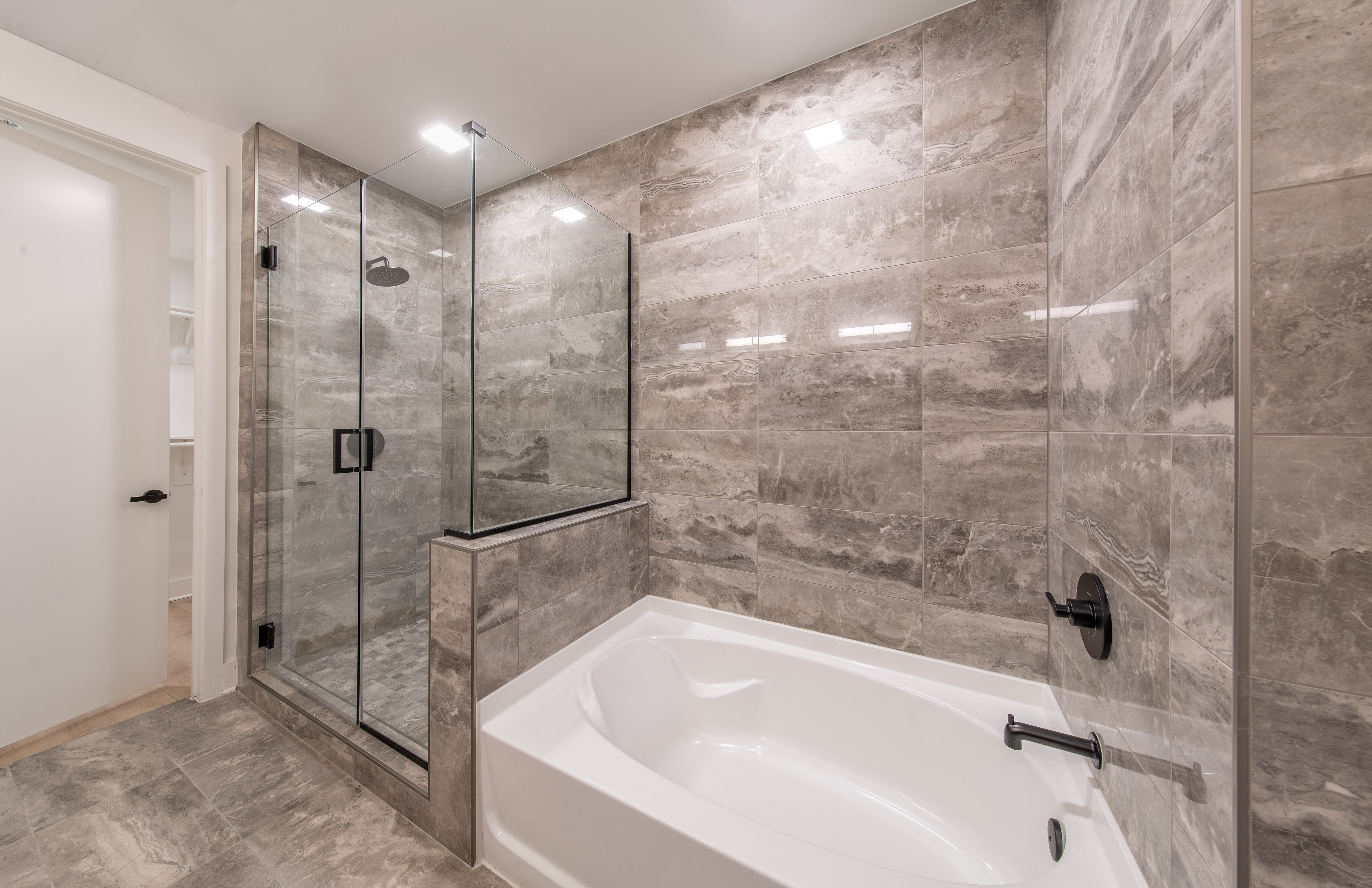 a large bathroom with a large tub and a shower